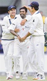World XI players Rahul Dravid and Virender Sehwag (left) congratulate team-mate Muttiah Muralitharan after he took the wicket of Australia's Matthew Hayden on the first day of the Super Series Test match at the Sydney Cricket Ground on Friday