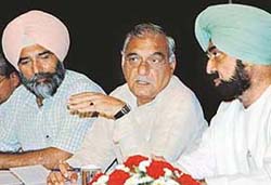 Haryana Chief Minister, Mr Bhupinder Singh Hooda, has a word with Punjab Minister, Mr Jagmohan Singh Kang while Mr Jagdeep Singh Cheema, Chairman of the Dr Amrik Singh Cheema Foundation Trust, is all ears at a seminar in Chandigarh
