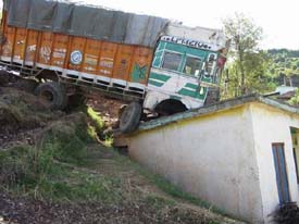 The house of Mohammad Rashid in Surankote, Poonch, withstood the October-8 quake but was damaged when a fully-loaded truck skidded off the road and landed on the roof on Friday