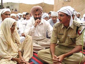 Civil and BSF officials console the mother of Parsa Ram, BSF jawan who was found dead at Kooch Behar in West Bengal on October 6, during Shradhanjali Samagam at Sappanwali village near Abohar