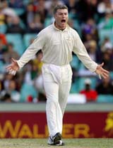 Australias Stuart MacGill celebrates taking the wicket of World XI player Andrew Flintoff on the second day of the Super Test at the Sydney Cricket Ground