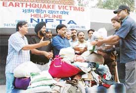 Members of the Northern India Film and Television Association collect relief material for earthquake victims at Tagore Theatre on Sunday