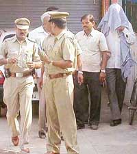 The arrested cop, Jagmal Singh, being produced before the Duty Magistrate in Panchkula on Monday
