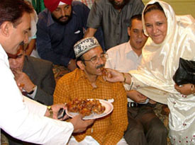 Delhi Congress chief Rambabu Sharma gets a taste of the delicacies at a Roza Iftar party at the DPCC office in the Capital on Monday