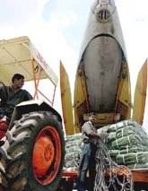 Employees from the Airport Authority of India load earthquake relief goods on to an aircraft in Bangalore on Monday.