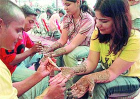With Karvachauth round the corner, girls beautify their hands at the Model Town market in Jalandhar