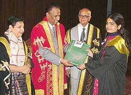Dr V.S. Prasad, Director, NAAC, gives a degree to a student at the convocation of the BBK DAV College in Amritsar on Wednesday. Also seen in the picture are senior vice-president of the college management Justice R.N. Mittal.