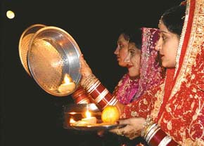 Fast of faith: Women offer prayers after watching Karva Chauth moon in Chandigarh on Thursday.