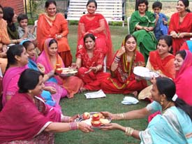Women exchange karva thalis with friends in Ludhiana on Thursday