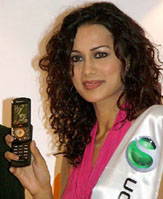 A model showcases a mobile handset at Mobile Expo, 2005, in New Delhi on Friday.