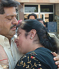 Subash Tandon of Jammu, who was injured in the earthquake in PoK, being received by his sister Anita Mehta at Wagah joint checkpost.