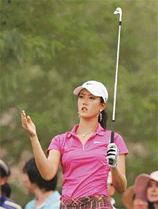 Golfs glamour girl Michelle Wie, on her professional debut in the Womens World Championship, finished fourth but was later disqualified due to an error on her scorecard resulting from a relief drop she made during the third round