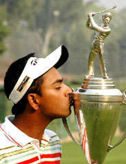 Anirban Lahiri kisses the Royal Challenge Samarvir Sahi trophy after emerging winner at the Chandigarh Golf Club on Friday