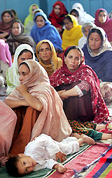 Sikh earthquake survivors, who were evacuated from Batagram, wait to get relief goods at Gurdwara Punja Sahib in Hasanabadal on Thursday