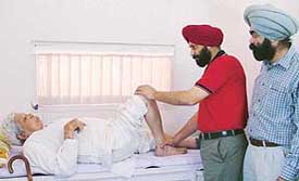 Doctors examine a patient at a free orthopaedic check-up camp at Upkar Diagnostics and Physiotherapy Centre in Ludhiana on Friday. 