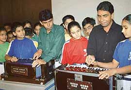 Ustad Ahmed Hussain and Ustad Mohammad Hussain explain finer nuances of classical music to students of The Gurukul, Panchkula, on Saturday.