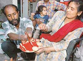 Though severely disabled Mohinder Singh and his wife Sushila do everything they can to earn their livelihood through dignified means. In this picture Mohinder is seen painting divas with his incomplete forelimbs.