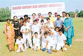 Dronacharya awardee D.P. Azad poses with the cricket team of St Johns High School, Chandigarh, which won the 8th blessed Edmund Rice under-11 Cricket Tournament on Sunday.