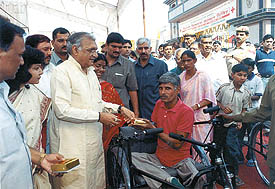 Haryana Chief Minister Bhupinder Singh Hooda distributing tricycles to the physically challenged persons at Ballabhgarh on Sunday