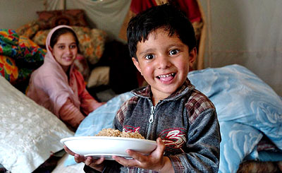 An earthquake survivor smiles at a refugee camp in Islamabad on Sunday