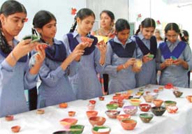 Students of Baba Isher Singh School, Ludhiana prepare decorative diyas at a competition held on Monday