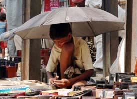 A boy sells and repairs purses at Ghanta Ghar Chowk in Ludhiana