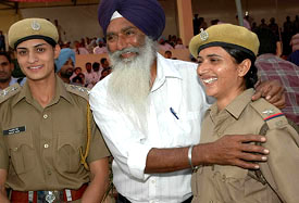 Rajwinder Kaur Gill , with her father, is all smiles after being promoted as ASI in Jalandhar on Monday. Manjit Kaur was also promoted as Inspector 