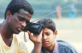 Two visually challenged Karnataka players listen to India-Sri Lanka one-day cricket commentary on their transistor during the National Sports Meet for physically challenged at Panjab University in Chandigarh