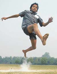 Deva Raju, a physically challenged boy, tries the long jump hurdle during the National Sports Meet for Physically Challenged persons held on the PU grounds, Chandigarh