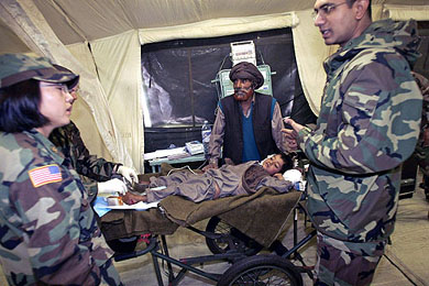 An earthquake victim waits for treatment at a US mobile army surgical hospital in Muzaffarabad