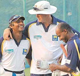 Sri Lankan star batsman Jayasuriya and coach Tom Moody with Kumar Sangakkara during a practice session on the eve of the second One-Day International cricket match in Mohali