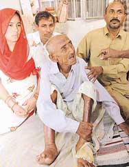 Ram Chand with his daughter-in-law and two sons who took him back home after The Tribune highlighted the abandoned old mans plight. 