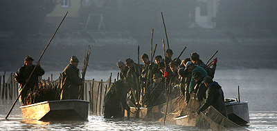 Fishermen fix a separating net in Dvoriste lake near the south Bohemian town of Trebon, Czech Republic, prior to the traditional Carp haul, on Friday