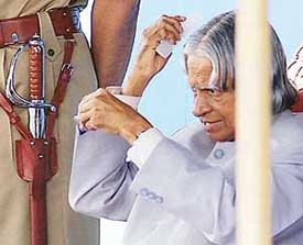 President A.P.J. Abdul Kalam combs his hair after inspecting the 66th anniversary parade of the CRPF in New Delhi on Saturday. 