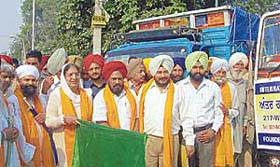 Deputy Chief Minister Rajinder Kaur Bhattal flags off trucks carrying relief material for the quake-hit in Jammu and Kashmir at Fatehgarh Sahib