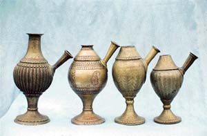 Some old huqqa water pots with ornamental designs on them