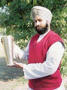 Sardar Inder Singh with a brass jug