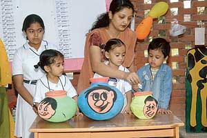 Tiny tots of Rai School, Sector 48, participate in a luck dip held to mark Divali celebrations at their school premises in Chandigarh on Sunday