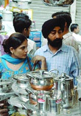 A Sikh couple buying utensils on the occasion of Dhanteras in the Capital on Sunday