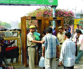 Delhi Police personnel frisking shoppers near Jama Masjid in the Capital on Sunday