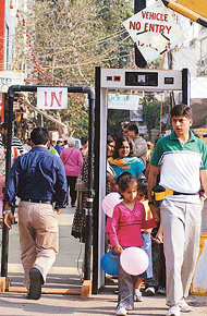 Shoppers enter through metal detectors at the M Block market of Greater Kailash 