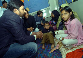 Pakistan captain Inzamam-ul-Haq talks to an earthquake survivor at the Pakistan Institute of Medical Science