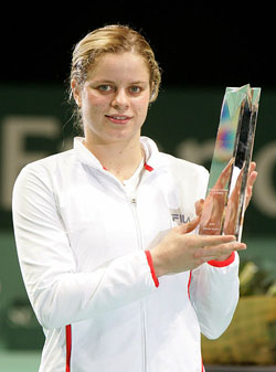 Kim Clijsters of Belgium shows her trophy after beating Italy's Francesca Schiavone in the final of WTA Gaz De France Stars tennis tournament in Hasselt