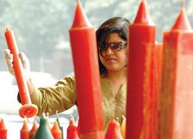 A girl selecting candles on the eve of Divali in the Capital on Monday.