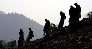 Kashmiri earthquake survivors walk down a steep mountain path in Dongikus on the Neelum Valley, north of Muzaffarabad, capital of Pakistan-occupied Kashmir, on Monday.