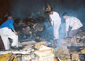 Scrapdealers sift through burnt scrap at Kabadi Market, Sector 55, in Chandigarh on Wednesday night
