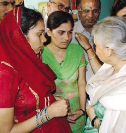 Chief Minister Sheila Dikshit reassures the sister and wife of the DTC bus driver Kuldeep Singh, injured in Govindpuri bomb blast, in the Capital