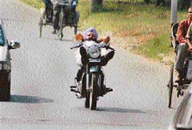 TAKE IT EASY: This rider was caught relaxing on the moving bike