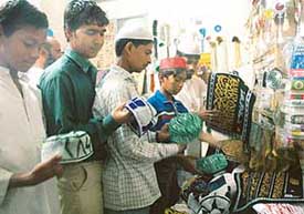 People buy caps at Sector 20, Chandigarh, on the eve of Id on Thursday