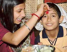 A sister applies tilak on the forehead of her brother on the occasion of Bhai Dooj, celebrated with traditional fervour in Chandigarh on Thursday